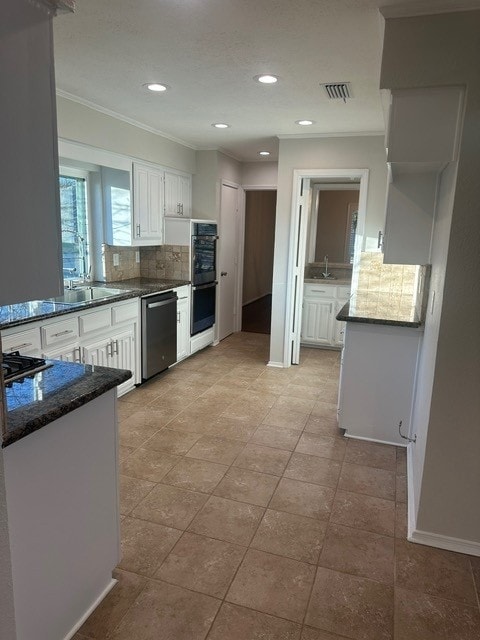 kitchen with dobule oven black, stainless steel dishwasher, visible vents, and white cabinets