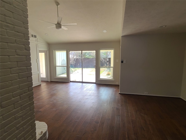 unfurnished living room with dark hardwood / wood-style flooring, vaulted ceiling, and ceiling fan