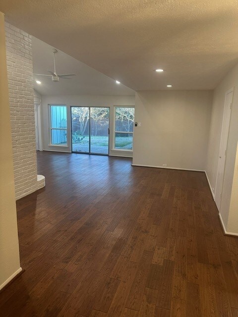 unfurnished room featuring baseboards, dark wood finished floors, a ceiling fan, a textured ceiling, and recessed lighting