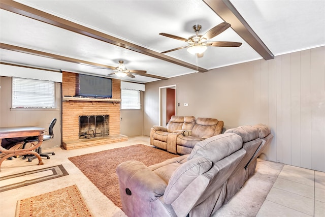 tiled living room featuring beamed ceiling, ceiling fan, a healthy amount of sunlight, and a brick fireplace