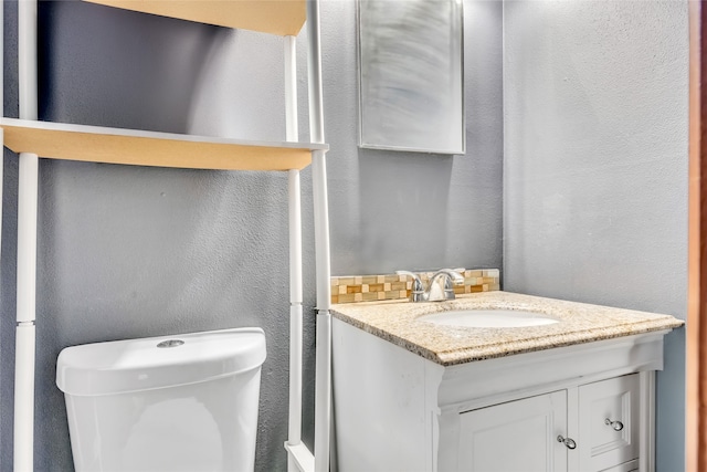 bathroom with toilet and vanity