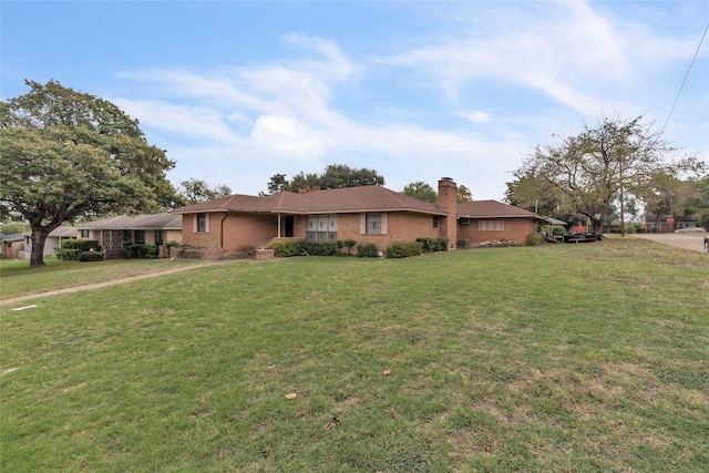 ranch-style house featuring a front lawn