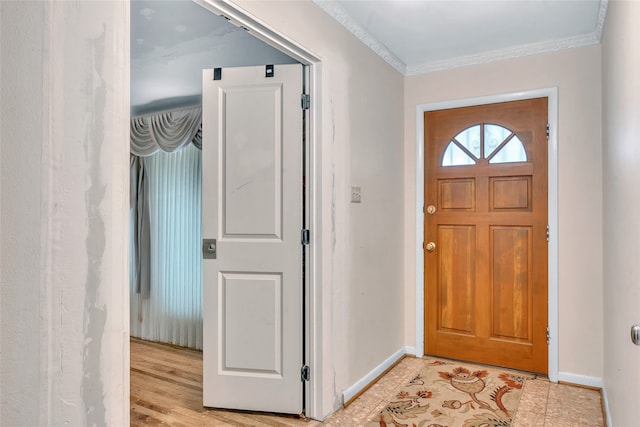 foyer featuring light hardwood / wood-style flooring and crown molding