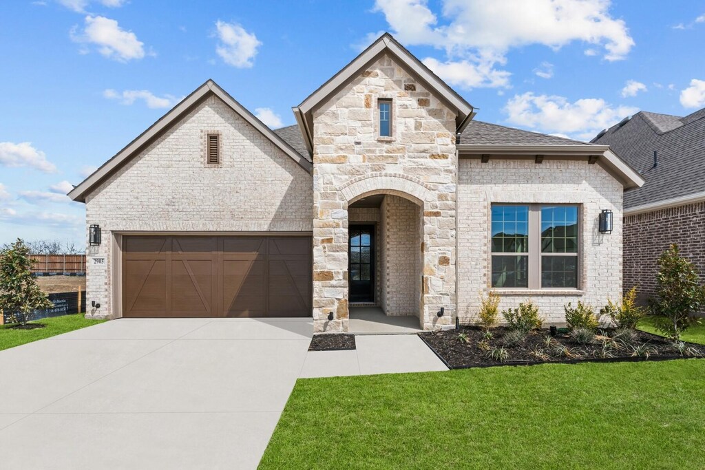 view of front facade with a garage and a front lawn