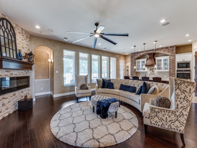 living room featuring dark hardwood / wood-style flooring and ceiling fan