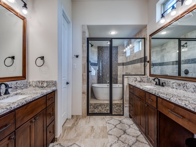 bathroom with vanity and separate shower and tub