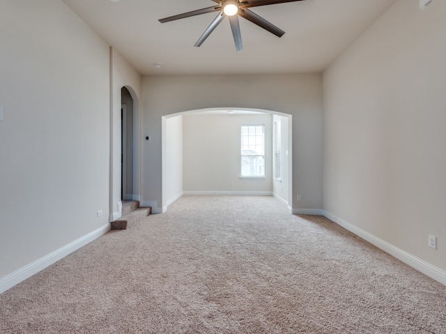 carpeted empty room featuring ceiling fan