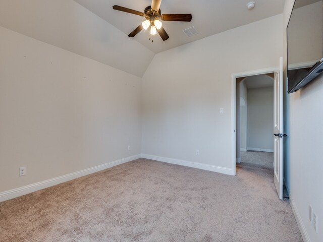 carpeted empty room featuring lofted ceiling and ceiling fan