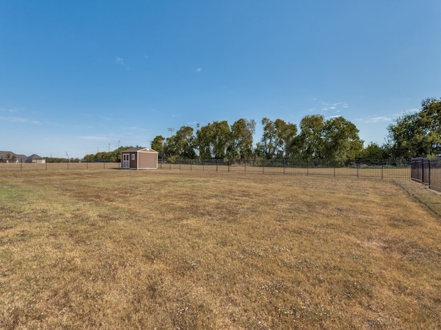 view of yard featuring a storage shed and a rural view