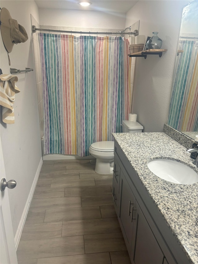 full bathroom featuring hardwood / wood-style flooring, vanity, toilet, and shower / bath combo