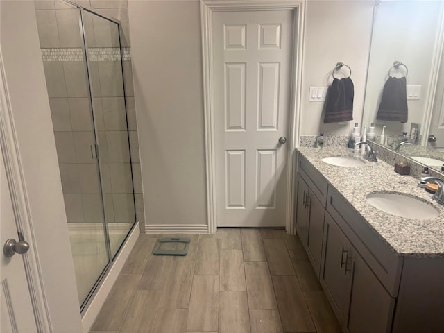 bathroom with vanity and a shower with door