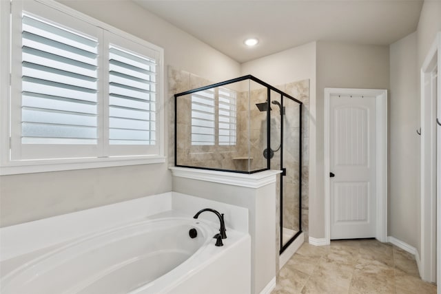 bathroom featuring independent shower and bath