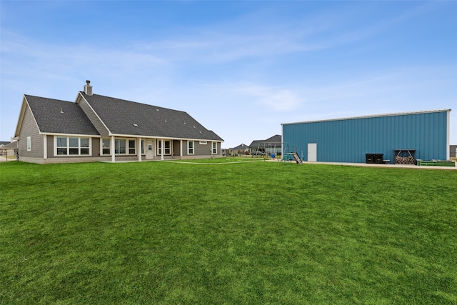 rear view of house with a yard