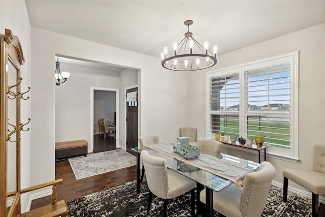 dining room featuring dark hardwood / wood-style flooring and a notable chandelier