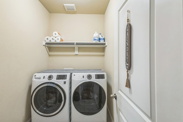 washroom with separate washer and dryer