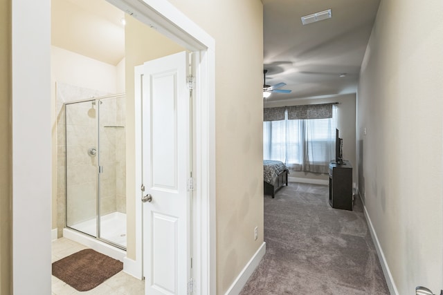 interior space with an enclosed shower and ceiling fan