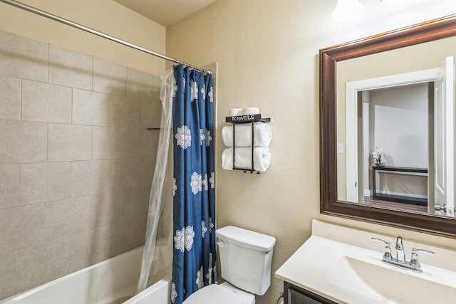 full bathroom featuring vanity, toilet, and shower / tub combo with curtain