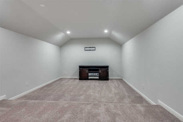 bonus room featuring light colored carpet and vaulted ceiling