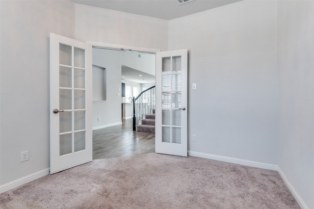 unfurnished room with french doors and carpet