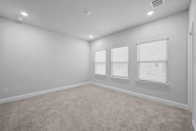 spare room with light carpet