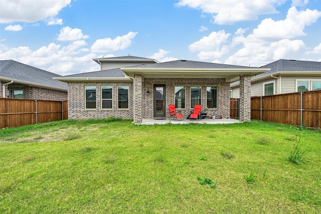 back of property featuring a patio and a lawn