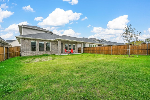 back of property featuring a lawn and a patio area