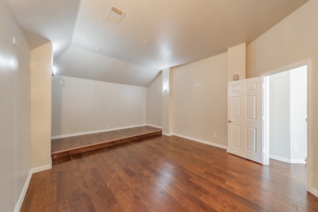 additional living space with lofted ceiling and hardwood / wood-style floors