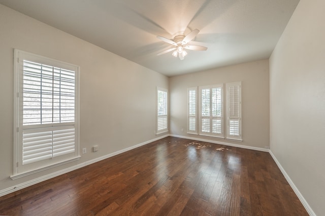 spare room with ceiling fan and dark hardwood / wood-style flooring