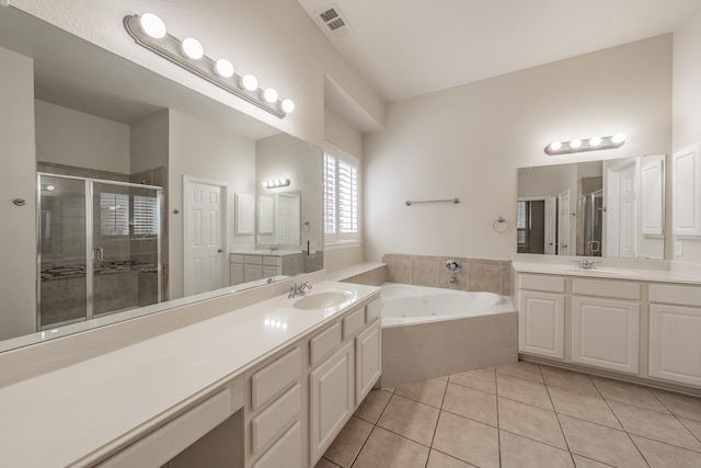 bathroom with vanity, tile patterned floors, and plus walk in shower