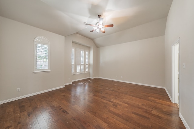 empty room with lofted ceiling, dark hardwood / wood-style floors, and ceiling fan