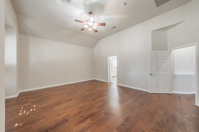 empty room with dark wood-type flooring, ceiling fan, and vaulted ceiling