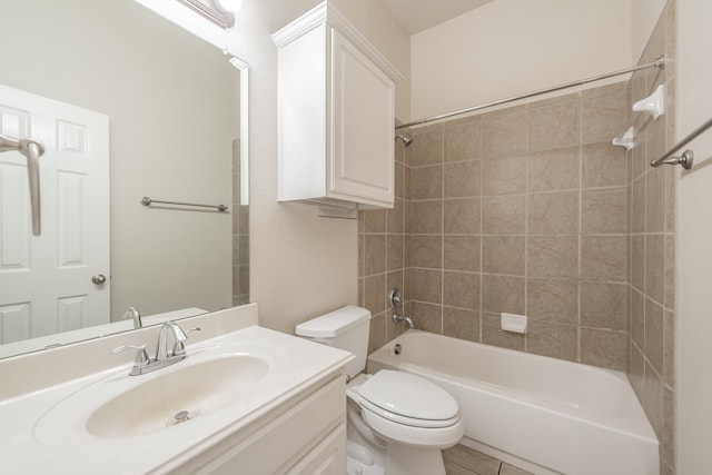 full bathroom featuring toilet, tiled shower / bath combo, vanity, and tile patterned floors