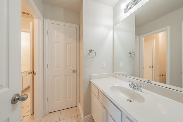 bathroom with tile patterned flooring and vanity