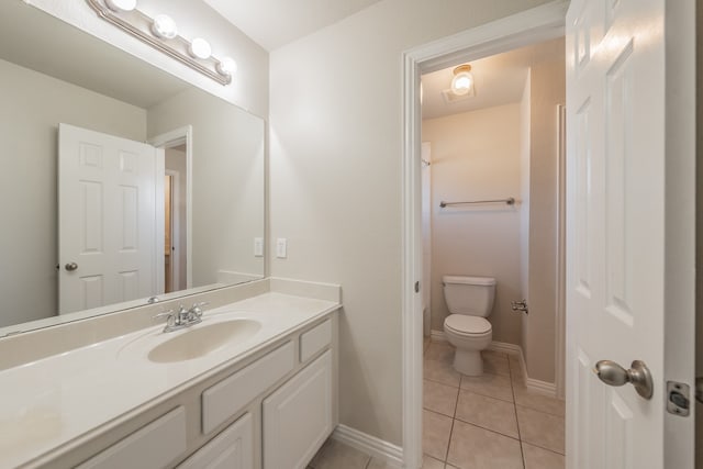 bathroom featuring tile patterned flooring, vanity, and toilet