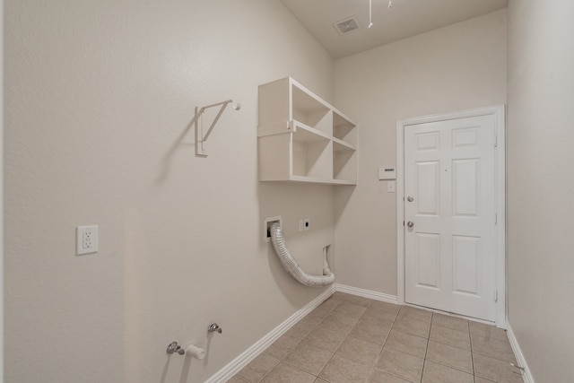 laundry room featuring hookup for an electric dryer, light tile patterned floors, and hookup for a gas dryer