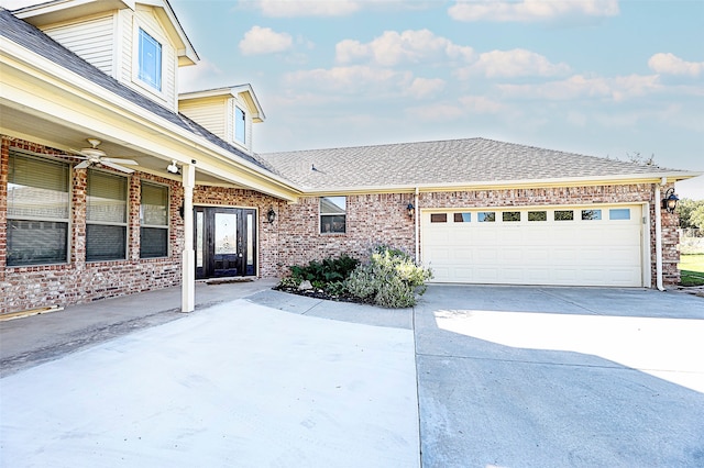 view of front of property featuring a garage and ceiling fan