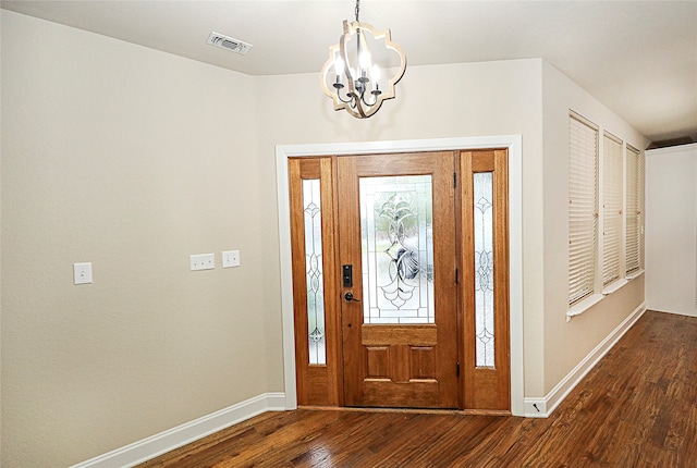 entrance foyer with wood-type flooring and a chandelier