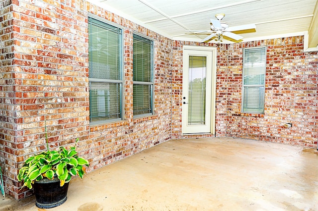 view of exterior entry featuring a patio and ceiling fan