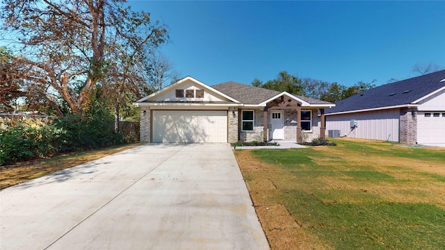 view of front facade with a front lawn, a garage, and cooling unit