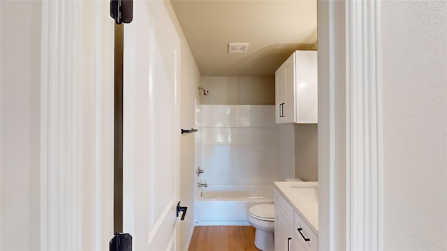 full bathroom featuring hardwood / wood-style floors, vanity, toilet, and bathtub / shower combination