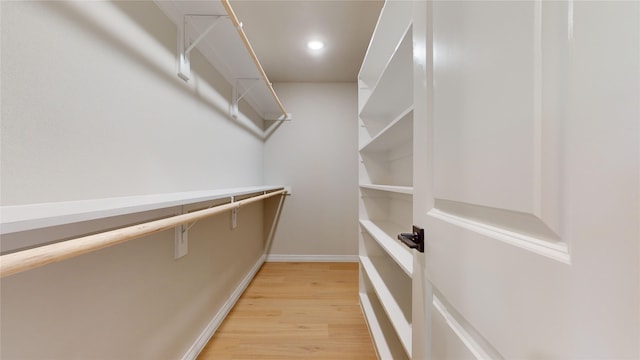 spacious closet with light hardwood / wood-style flooring