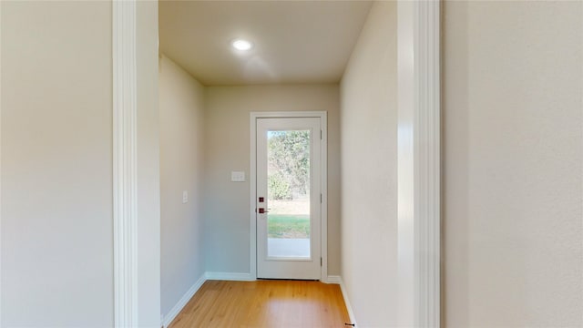 doorway with light wood-type flooring