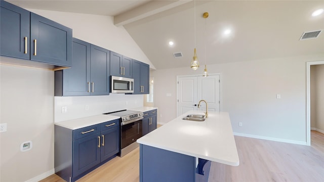 kitchen featuring stainless steel appliances, blue cabinetry, decorative light fixtures, sink, and light hardwood / wood-style floors