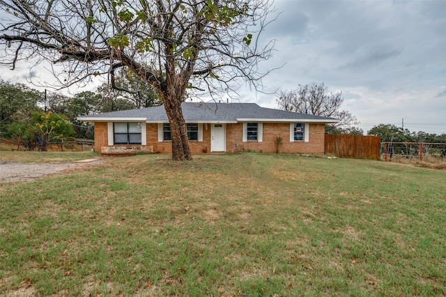 ranch-style home featuring a front yard