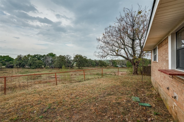 view of yard with a rural view