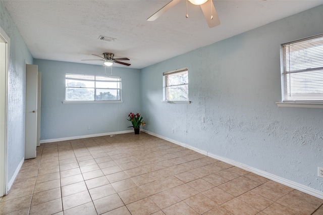 spare room featuring ceiling fan and light tile patterned floors