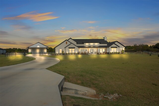 view of front of home featuring a garage and a lawn