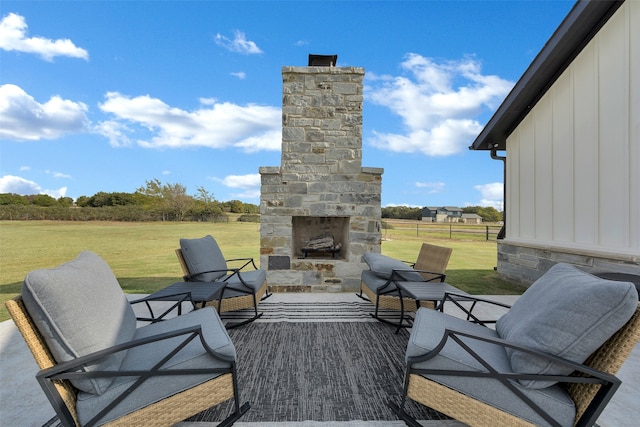 view of patio featuring an outdoor stone fireplace