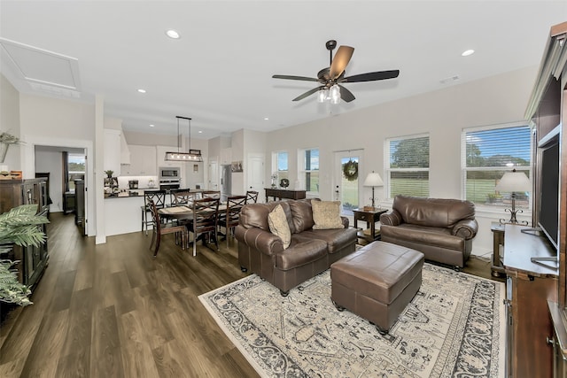 living room featuring dark hardwood / wood-style flooring, a healthy amount of sunlight, and ceiling fan