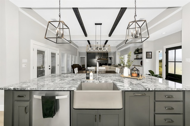 kitchen with gray cabinetry, a center island with sink, decorative light fixtures, sink, and dishwasher